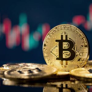 Golden bitcoin coin over defocused stock chart with copy space, Olsztyn, Poland 13 July 2021